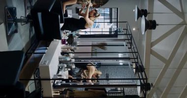 A stylish and chic salon scene showcasing hair stylists and clients actively engaged in various beauty treatments