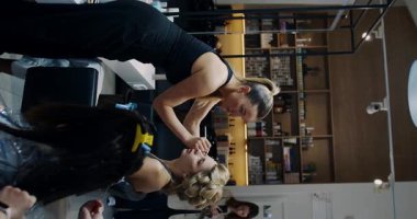 Two talented beauticians work together to create chic and stylish makeup looks in a modern salon environment