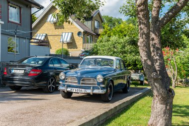 Sweden, Knislinge  July 2, 2022: An old retro vintage Volvo car in a private yard on a sunny summer day