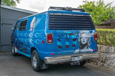 Sweden, Knislinge  July 2, 2022: An old retro vintage van car in a private yard with a print of Marilyn Monroe