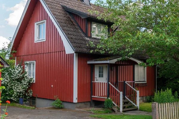 Typical red house in Sweden. A beautiful private wooden house in Europe in summer. European architecture, vintage.