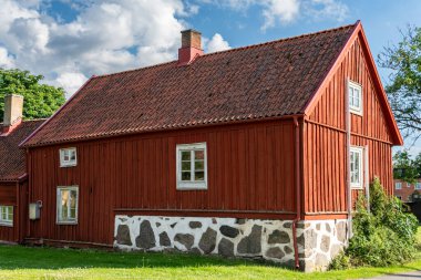Traditional old vintage red Swedish house from wood on a sunny day in summer