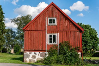 Traditional old vintage red Swedish house from wood on a sunny day in summer