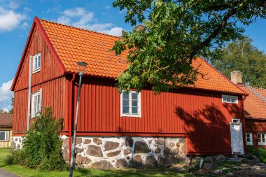 Traditional old vintage red Swedish house from wood on a sunny day in summer