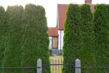 Sweden, Knislinge  July 3, 2022: Beautiful yard of a private house in Europe. Stylish architecture, concept of a building. Decorated facade. A lot of greenery and flowers on a summer day. Urbanism, urban area. 