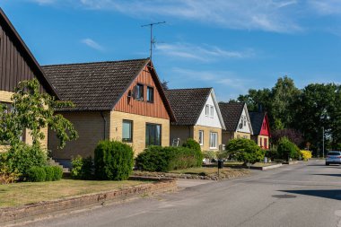 Sweden, Knislinge  July 30, 2022: Beautiful private houses along the street on a sunny summer day. European architecture, modern village. Cottage house, dacha. Cozy place for living. Real estate. 
