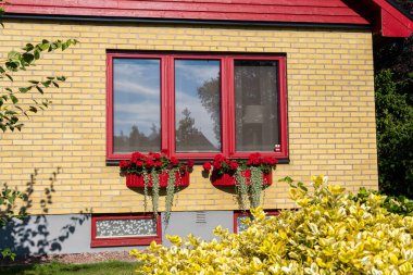 Sweden, Knislinge  July 30, 2022: Beautiful decorated facade of a typical private residential house in Europe. Architecture, stylish house. Concept of a building. Summer house. Vintage style.