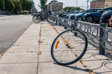 Sweden, Knislinge  August 22, 2022: A stolen bicycle on a parking, only a wheel is left. Vandalism, common problem in big cities.