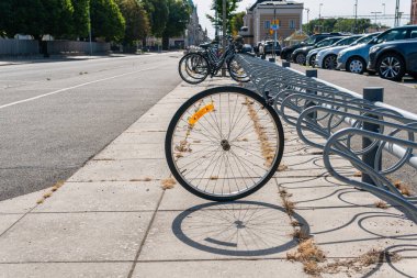Sweden, Knislinge  August 22, 2022: A stolen bicycle on a parking, only a wheel is left. Vandalism, common problem in big cities.