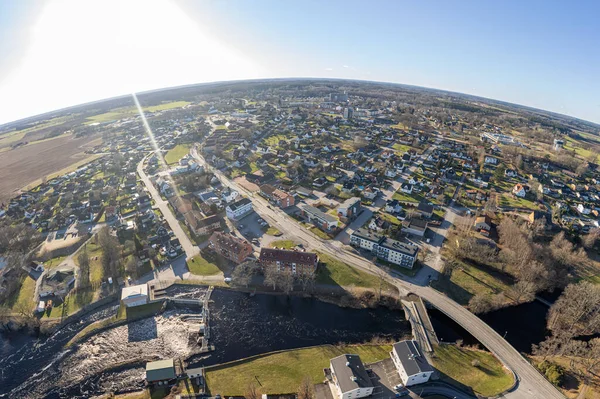 Aerial view on a little town in Europe, Sweden on a spring sunny day. Residential buildings, private houses. Lake and dam near residential house. Panorama of European village.