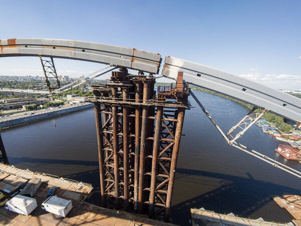 Ukraine, Kyiv  June 5, 2016: A big unfinished Podilskyi bridge over Dnipro. Huge rusty construction. Building industry.