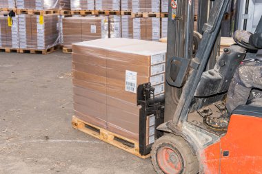 İsveç, Malmö 15 Kasım 2022: Bir depo kaldırma ve karton kutuları taşıma forklift 