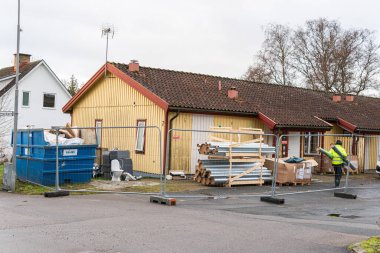 Sweden, Knislinge  January 3, 2023: renovation, refurbishment, overhaul, refit, capital repairs of a wooden house. Running repairs, routine. Maintenance of a building.  clipart