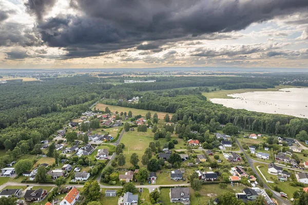 Stock image Aerial view of a little European beachfront village with private houses surrounded by trees and sea, village on island, resort town.  