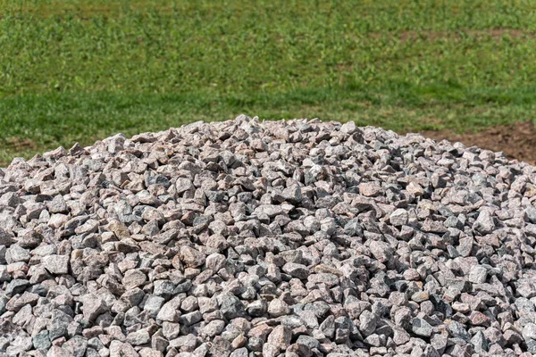 A big pile of stones on the ground outdoors