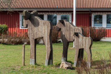 Sweden, Knislinge  March 29, 2024: Wooden moose, wood sculpture, symbol of Sweden clipart