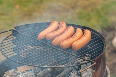 Sosisler açık havada ızgara yapıyor.