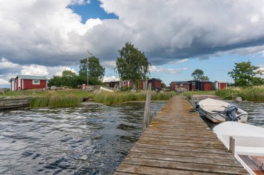 Sweden, Token  July 22, 2023: Beautiful and cozy wooden fishermen's cottages by the sea in Scandinavian style. Small vacation cabins. clipart