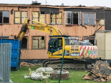 Sweden, Malmo  September 20, 2024: A large excavator is demolishing an old building clipart