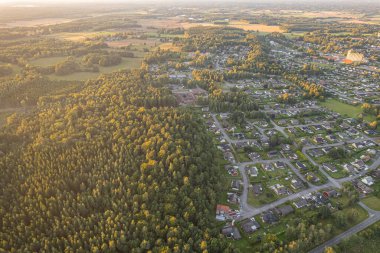 View of a small European town from a drone. Many private and residential houses. A cozy place to live with developed infrastructure. clipart