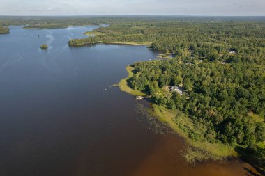 Beautiful recreational area in nature near a forest and lake. Aerial view. National park and swimming area. clipart