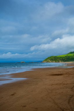 Beach and ocean. Atlantic coast of Spain, vertical photo.