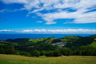 Landscape overlooking the green hills and the Atlantic Ocean. Coast of Basque Country, Spain.