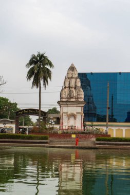 Bangladesh, Rajshahi - 04.21.2023: Hindu Temple Math Pukur pond and Showroom Sopura Silk Mills Ltd, Rajshahi, Bangladesh clipart