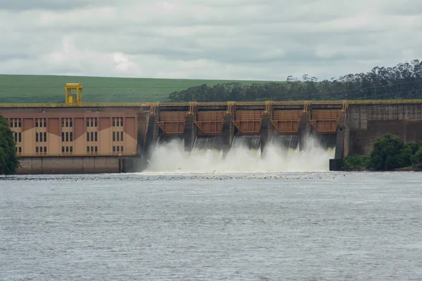 Barra Bonita dam with open hydroelectric plant gates. The Barra Bonita Lock is used for vessels to cross the gaps between the upper and lower levels of the dam.