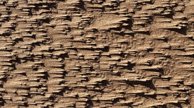 İnce taneli altın kumun karmaşık dokuları doğal ve detaylı bir zemin oluşturur. Sıcak renk varyasyonlarıyla kumların granüler yapısı ve ışık ve gölgenin oluşturduğu hassas desenler.