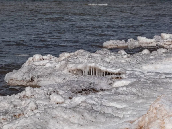 Stock image Seascape depicting landscape of Baltic sea and beach with ice and snow formations on the shore in bright sunlight. Frozen ice blocks and sea water in winter