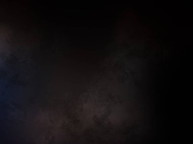 Takım elbiseli ve kravatlı bir adam karanlık bir arka planın önünde duruyor.