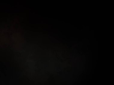 Elinde mikrofon tutan takım elbiseli ve kravatlı bir adam.