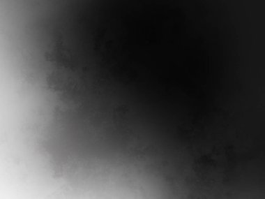 Siyah beyaz bir fotoğrafın önünde duran takım elbiseli ve kravatlı bir adam.