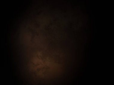 Ortasında ışık olan koyu bir arkaplan.