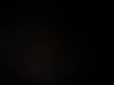 Elinde mikrofon tutan takım elbiseli ve kravatlı bir adam.