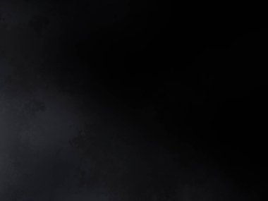 Siyah bir arka planın önünde duran takım elbiseli ve kravatlı bir adam.