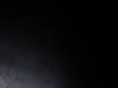 Siyah bir arka planın önünde duran takım elbiseli ve kravatlı bir adam.