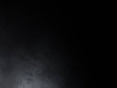 Siyah bir arka planın önünde duran takım elbiseli ve kravatlı bir adam.