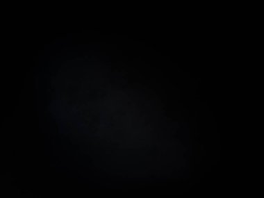 Siyah gömlekli bir adam elinde kamera tutuyor.