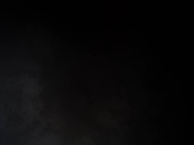 Siyah gömlekli bir adam elinde kamera tutuyor.