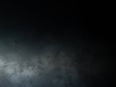 Takım elbiseli ve kravatlı bir adam karanlık bir arka planın önünde duruyor.