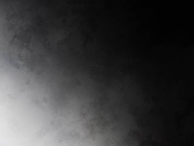 Siyah gömlekli bir adam tenis raketi tutuyor.