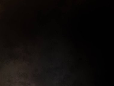 Takım elbiseli ve kravatlı bir adam ateşin önünde duruyor.