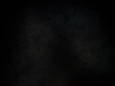 Siyah bir arka planın önünde duran takım elbiseli ve kravatlı bir adam.