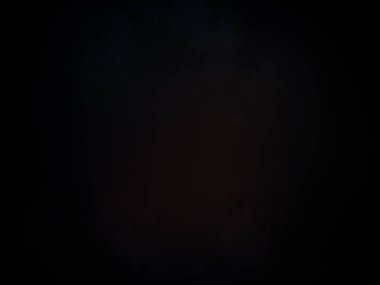 Karanlıkta siyah arka planı olan kırmızı bir ışık.