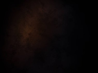 Koyu turuncu ve sarı ışıklı siyah bir arkaplan.