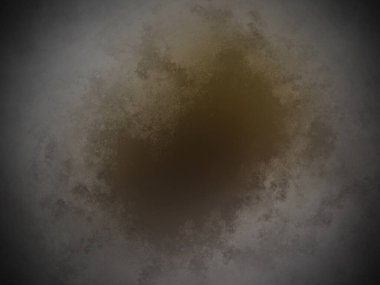 Siyah arkaplanın ortasında kahverengi bir madde.