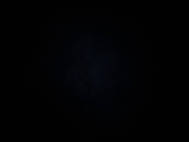 Ortasında ışık olan siyah bir arkaplan