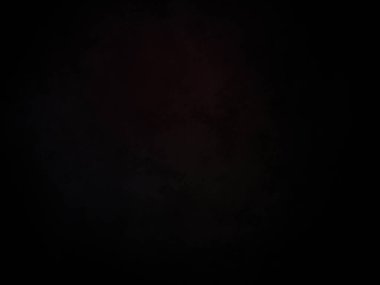 Karanlıkta siyah arka planı olan kırmızı bir ışık.